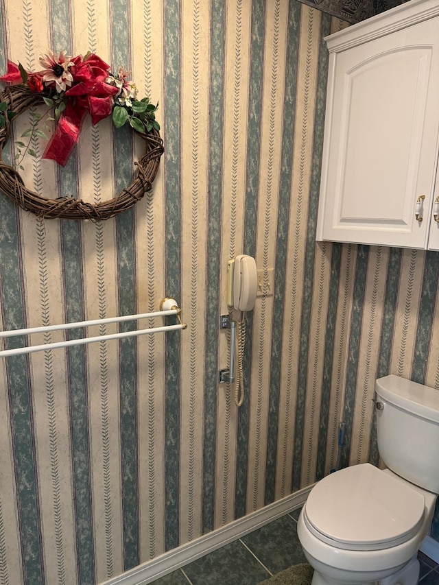 bathroom with toilet and tile patterned floors