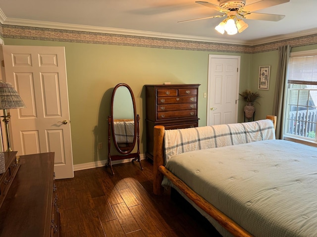 bedroom featuring crown molding, dark wood-type flooring, multiple windows, and ceiling fan