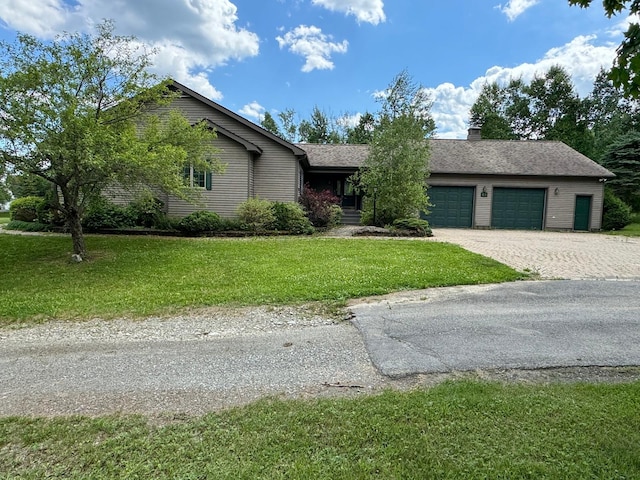 view of front of house with a garage and a front yard