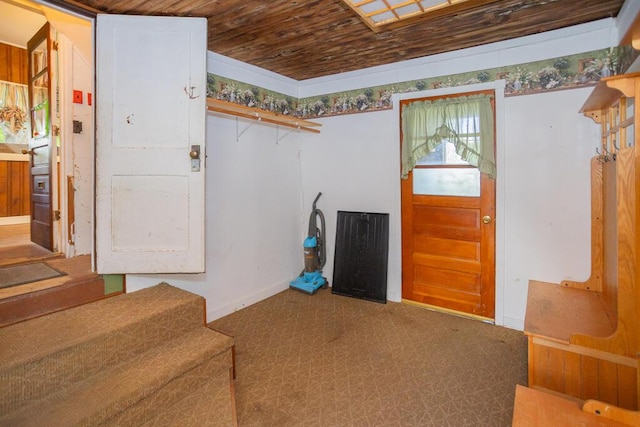 entryway with carpet flooring and wood ceiling