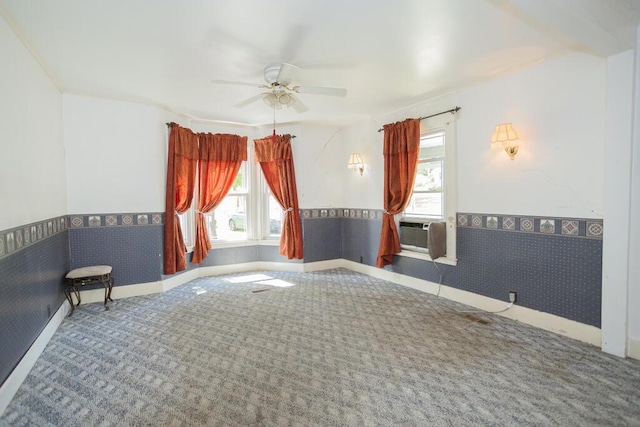 empty room featuring carpet flooring, ceiling fan, and cooling unit