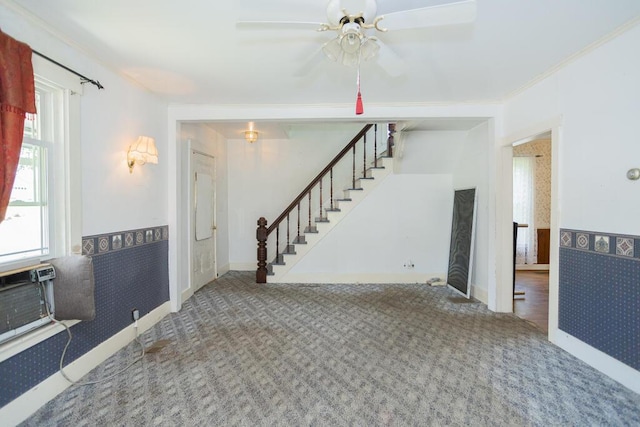 unfurnished living room featuring ceiling fan, carpet floors, and crown molding