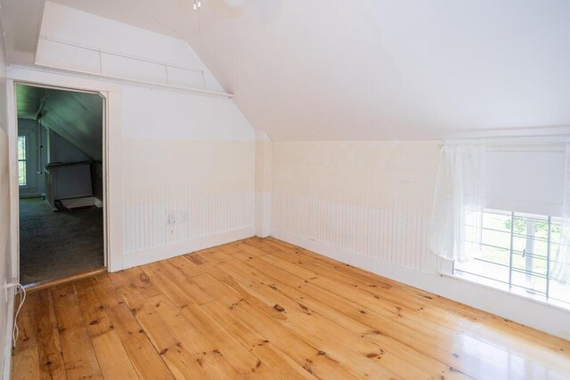 bonus room with vaulted ceiling and hardwood / wood-style flooring