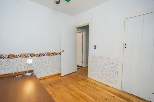 interior space with wood-type flooring and ceiling fan