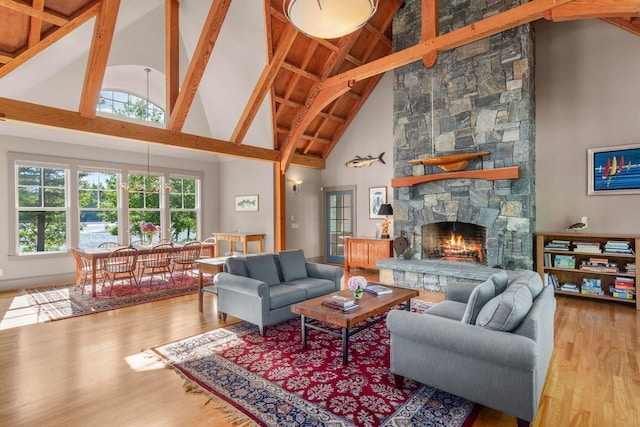 living room with beam ceiling, a fireplace, hardwood / wood-style flooring, and high vaulted ceiling