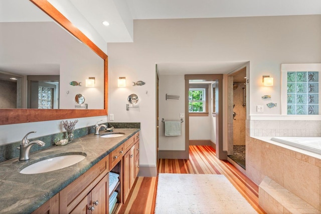 bathroom featuring vanity, wood-type flooring, and independent shower and bath