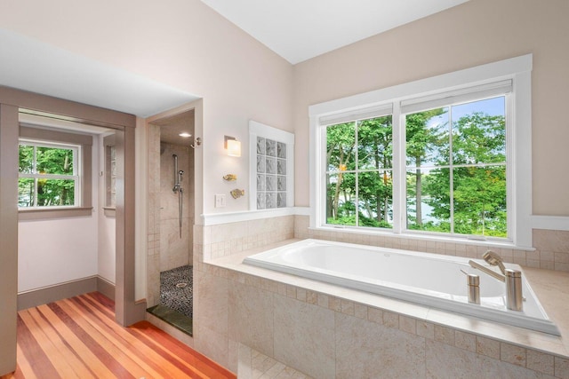 bathroom featuring separate shower and tub