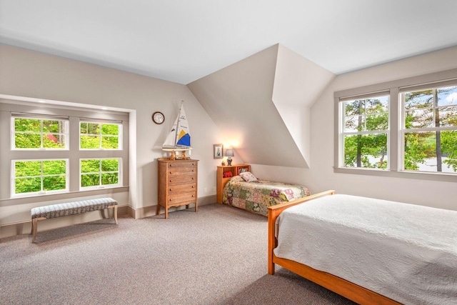 carpeted bedroom with lofted ceiling