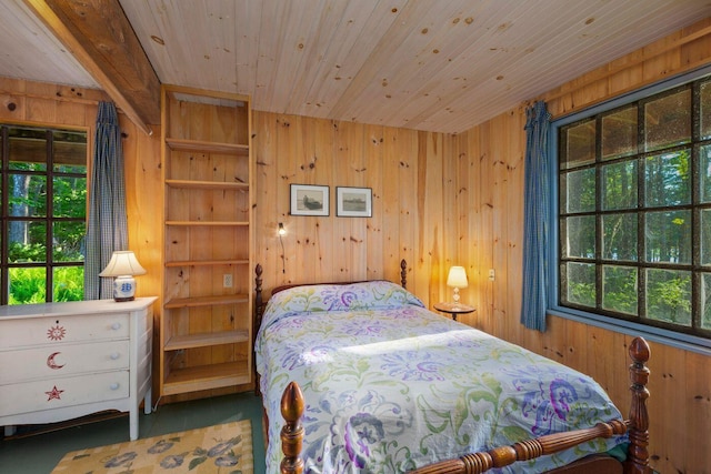 bedroom featuring multiple windows, wood walls, and wood ceiling