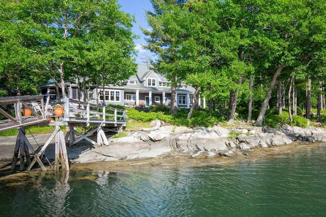 back of house featuring a water view