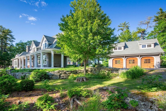 cape cod home featuring a garage