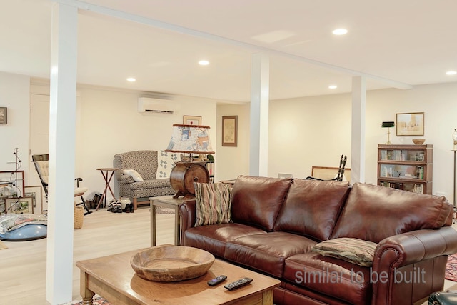 living room with light hardwood / wood-style flooring and a wall unit AC