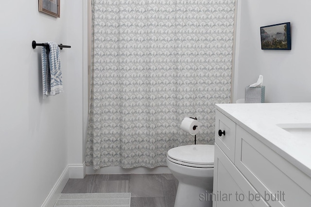 bathroom with toilet and vanity