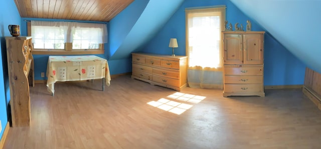 bedroom with vaulted ceiling, wooden ceiling, and light hardwood / wood-style flooring