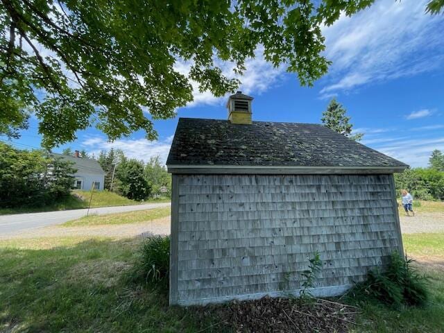 view of outbuilding featuring a lawn