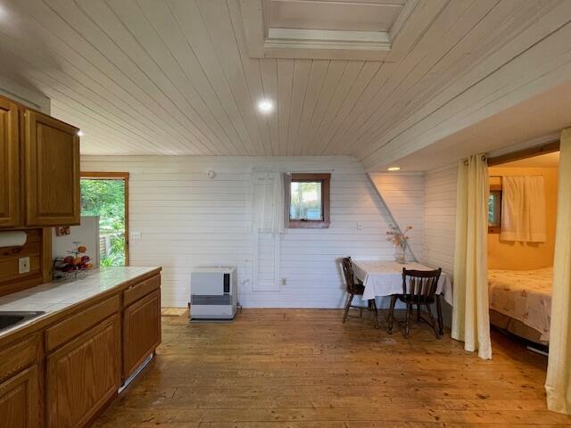 interior space with light wood-type flooring, wooden ceiling, and plenty of natural light