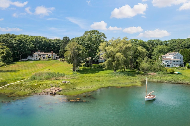 birds eye view of property with a wooded view and a water view