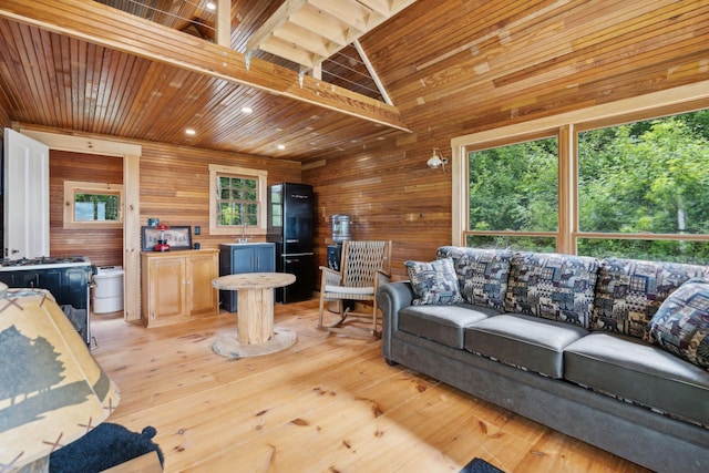 living room featuring light hardwood / wood-style floors, high vaulted ceiling, wooden walls, and wood ceiling