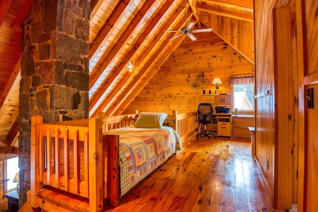 unfurnished bedroom with light hardwood / wood-style flooring, wooden walls, lofted ceiling with beams, and wooden ceiling