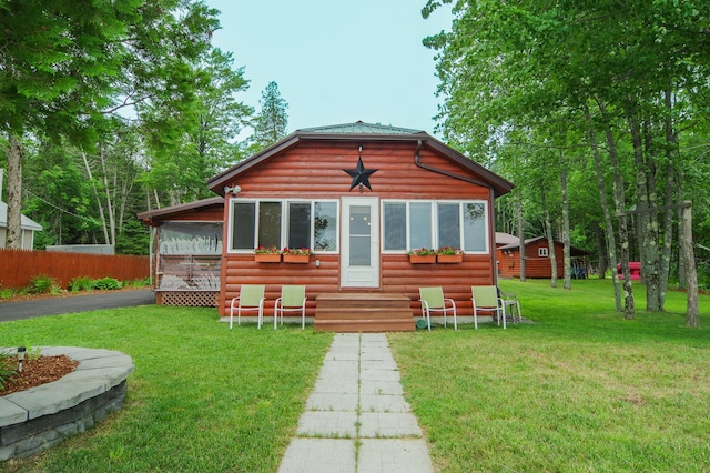 back of house featuring a lawn