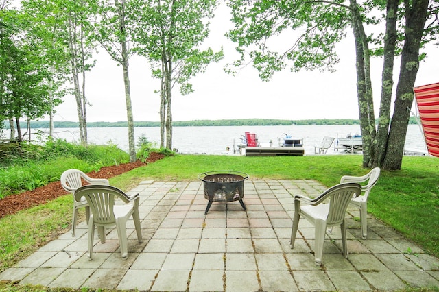 view of patio / terrace featuring an outdoor fire pit and a water view