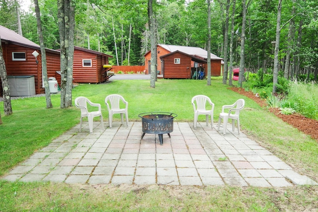 view of patio with an outbuilding and an outdoor fire pit