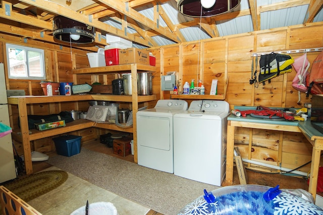 laundry room featuring washer and clothes dryer and wood walls