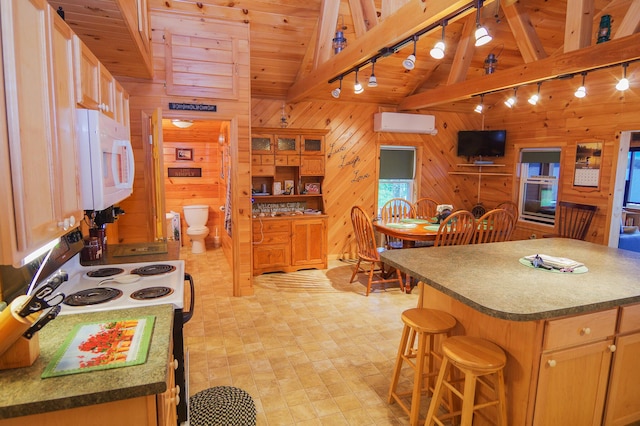 kitchen with a center island, vaulted ceiling with beams, wooden walls, track lighting, and wooden ceiling