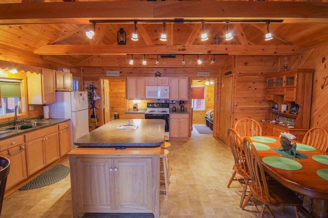 kitchen with rail lighting, sink, range with electric cooktop, and wooden walls