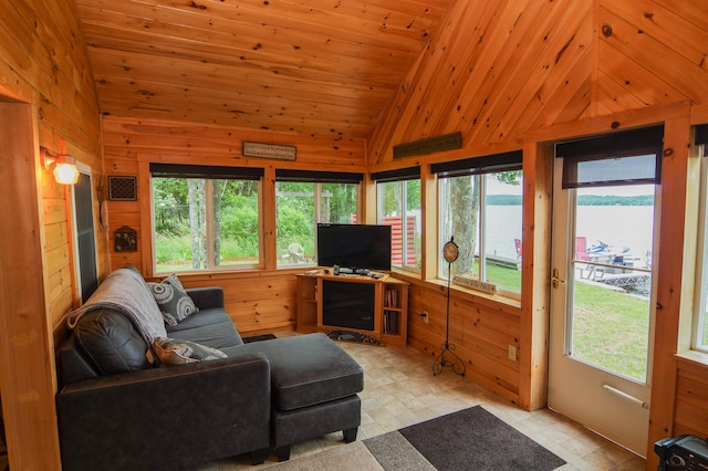 living room featuring high vaulted ceiling, wood ceiling, and wood walls