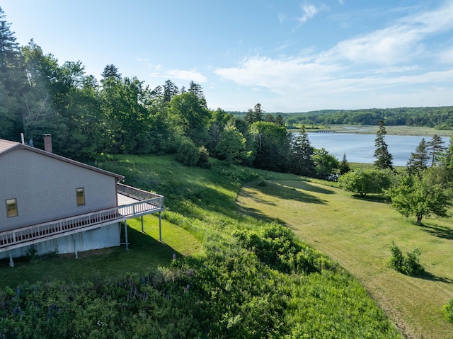 view of yard with a deck with water view