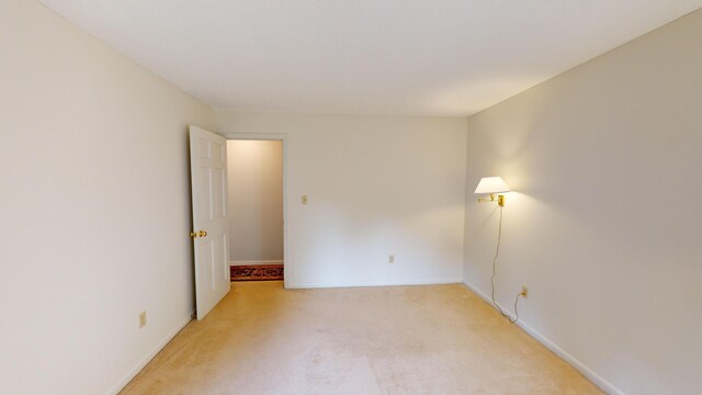 unfurnished room featuring light carpet