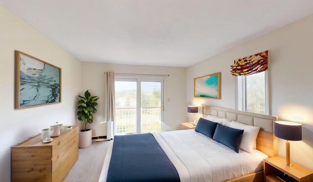 bedroom with access to exterior and light wood-type flooring