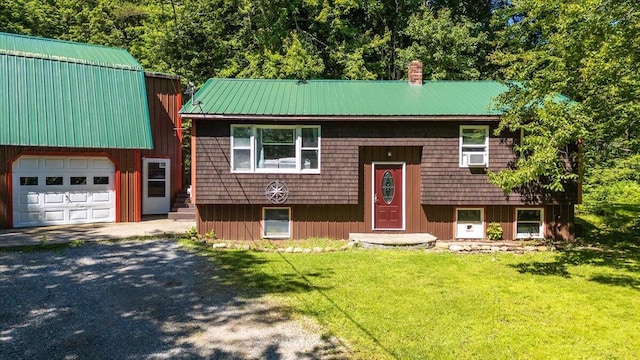 bi-level home featuring cooling unit, a front yard, and a garage