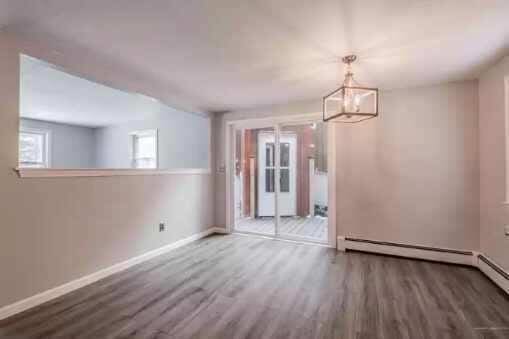 unfurnished dining area with hardwood / wood-style flooring and a notable chandelier