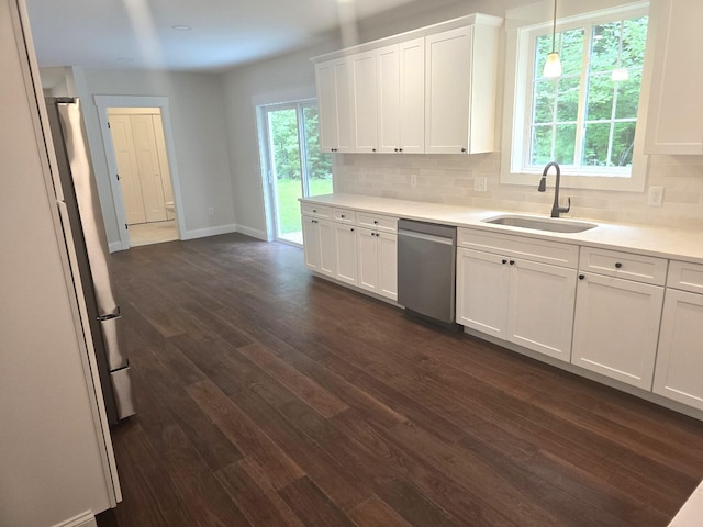 kitchen with dark wood-type flooring, a sink, backsplash, and stainless steel dishwasher