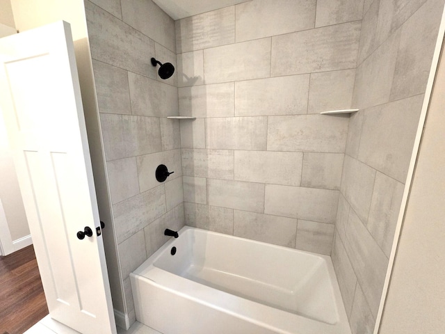 bathroom with bathtub / shower combination and wood finished floors