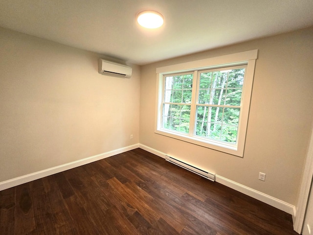 spare room with a baseboard radiator, baseboards, dark wood finished floors, and an AC wall unit