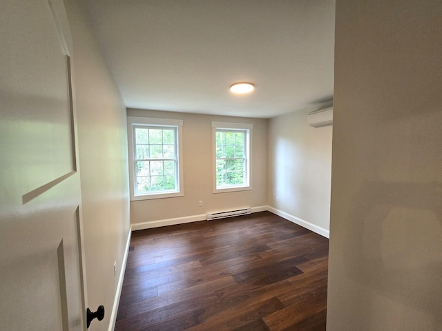 empty room featuring an AC wall unit, baseboard heating, dark wood finished floors, and baseboards