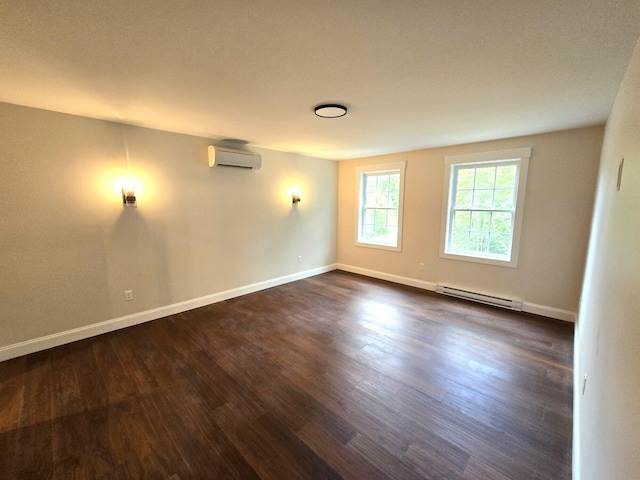 empty room featuring dark wood-type flooring, baseboard heating, a wall unit AC, and baseboards