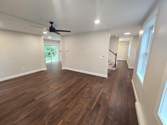 unfurnished room with baseboards, stairway, dark wood-type flooring, recessed lighting, and a ceiling fan