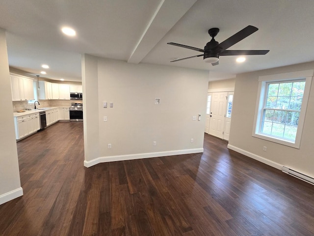 unfurnished living room with baseboards, ceiling fan, recessed lighting, and dark wood-type flooring