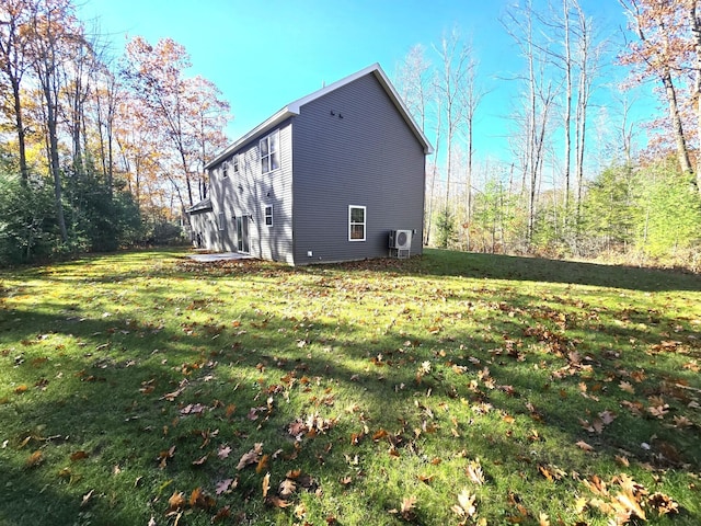 view of property exterior featuring ac unit and a yard