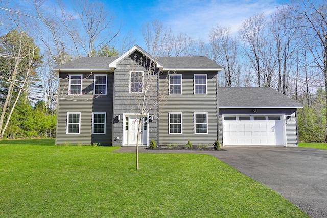 12 Country Dr, Old Orchard Beach, ME 04064 - colonial house featuring driveway, an attached garage, a front yard, and roof with shingles