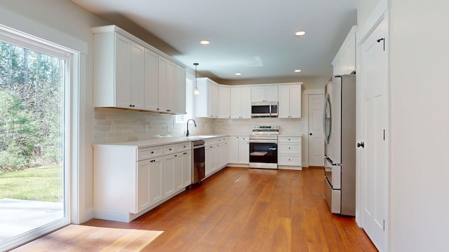 12 Country Dr, Old Orchard Beach, ME 04064 - kitchen featuring stainless steel appliances, a sink, wood finished floors, backsplash, and recessed lighting