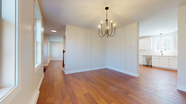 12 Country Dr, Old Orchard Beach, ME 04064 - unfurnished dining area with a chandelier, wood-type flooring, baseboards, a sink, and recessed lighting