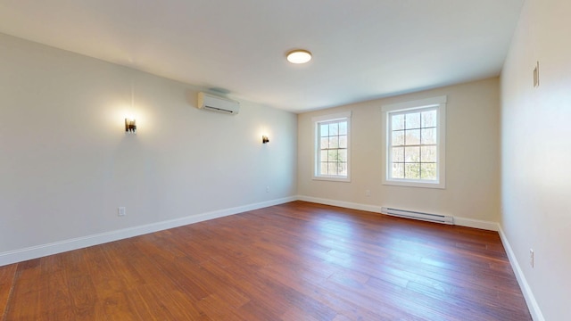 12 Country Dr, Old Orchard Beach, ME 04064 - empty room with a wall unit AC, a baseboard radiator, wood finished floors, and baseboards