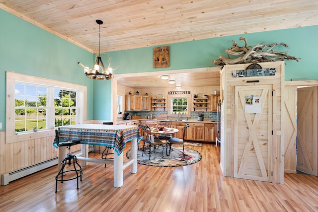 dining room with an inviting chandelier, light hardwood / wood-style floors, sink, wooden ceiling, and crown molding