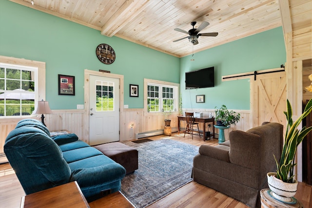 living room with beam ceiling, wooden ceiling, ceiling fan, a barn door, and light hardwood / wood-style floors