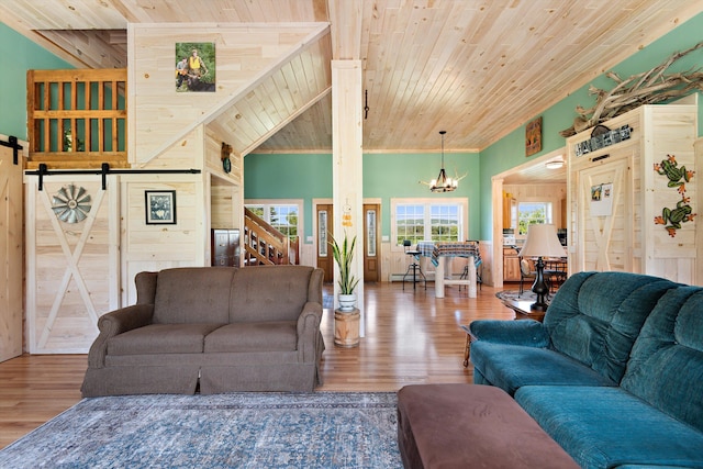 living room featuring wooden ceiling, hardwood / wood-style floors, a barn door, and wood walls